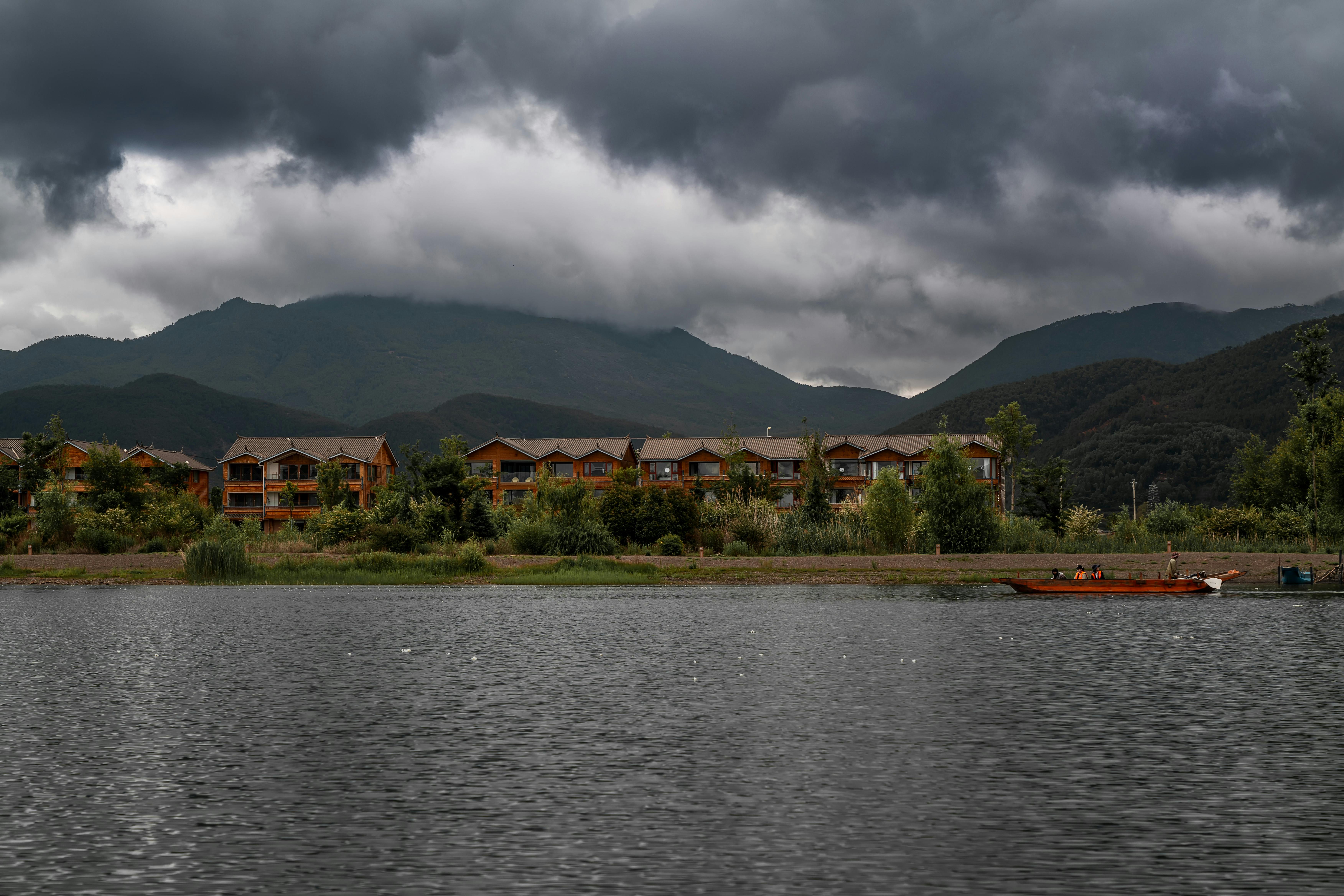 dramatic storm clouds gathering over a residential street in Birmingham - residential roofers birmingham al