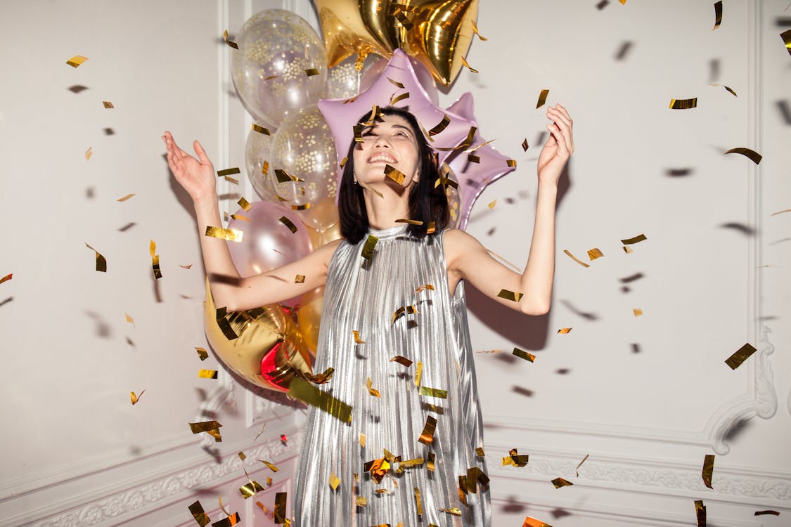 Free Woman Looking at Falling Confetti Stock Photo