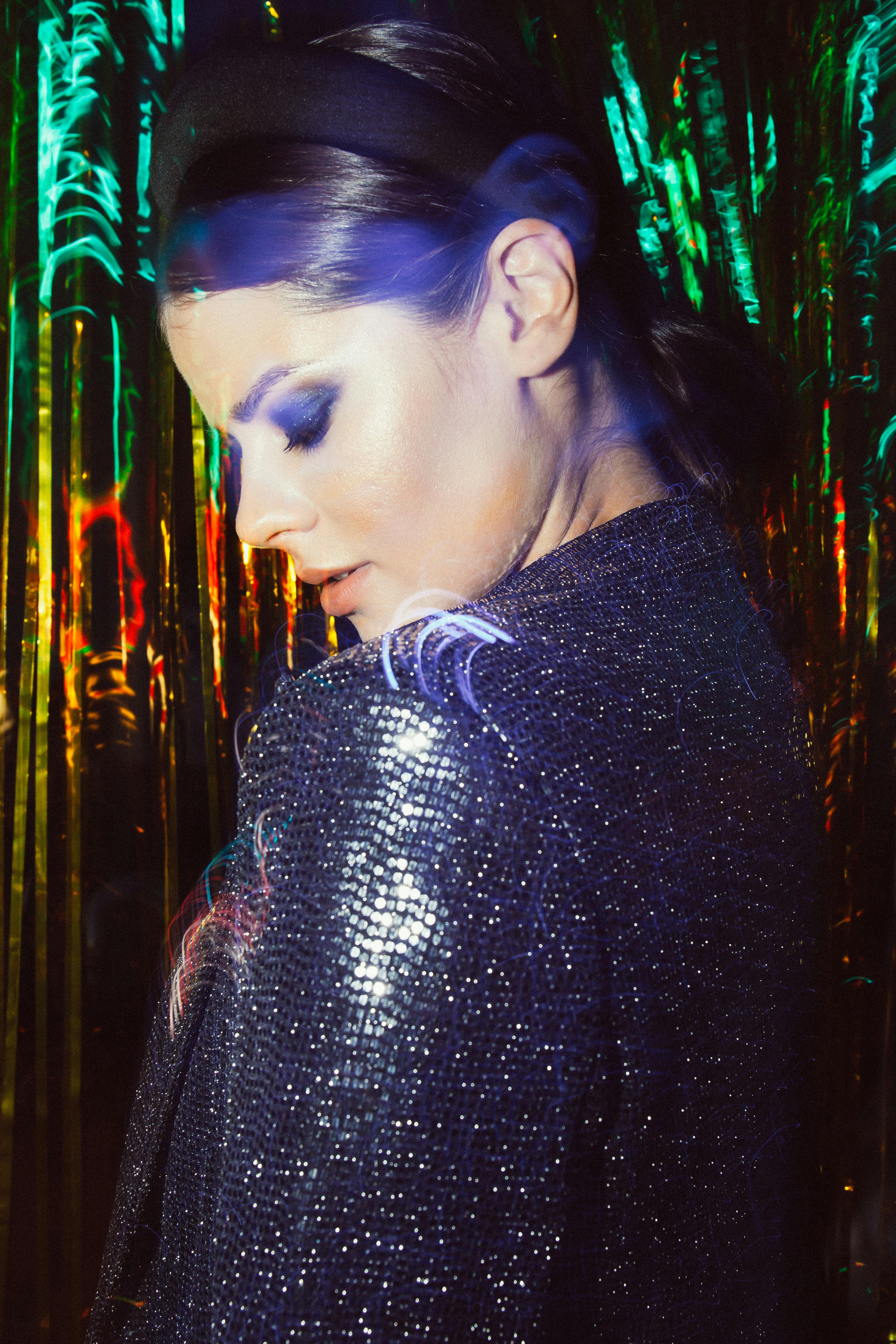 gratis Vrouw In Zwarte Trui Die Zich Dichtbij Groene Bladinstallaties Bevindt Stockfoto