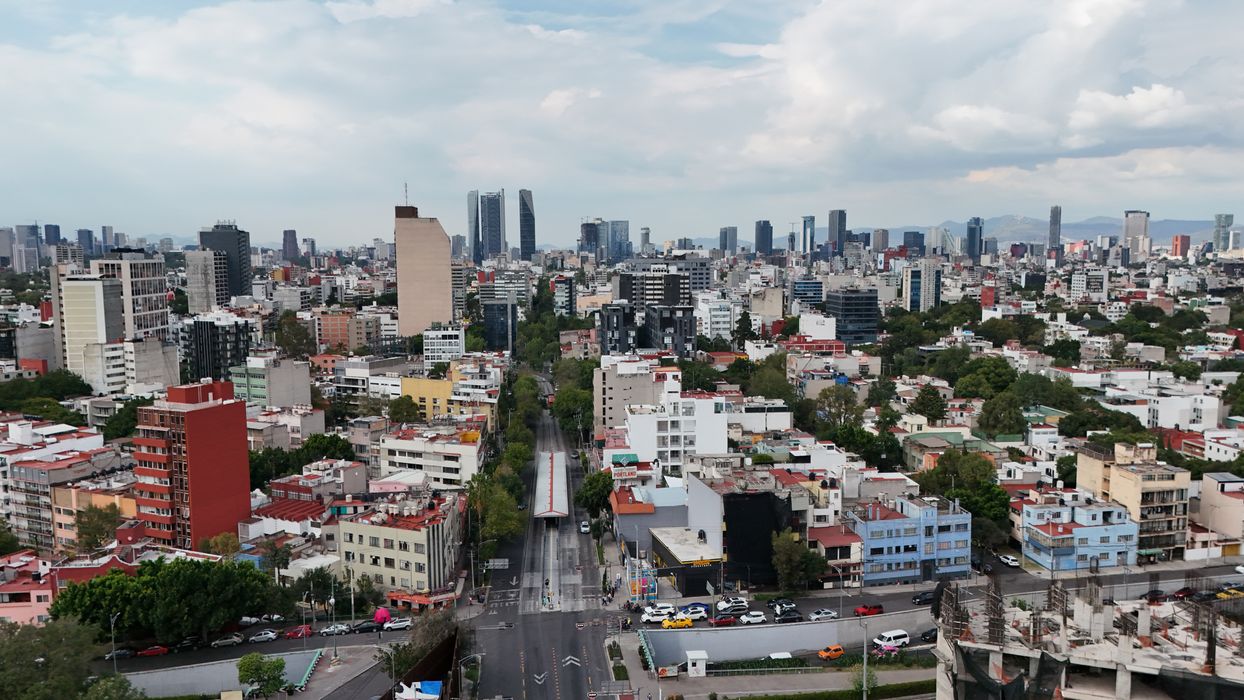 Aerial view of Mexico City skyline with skyscrapers and urban neighborhoods stretching to the horizon
