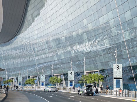 Stunning modern facade of an airport terminal in Abu Dhabi with reflective glass and contemporary design.