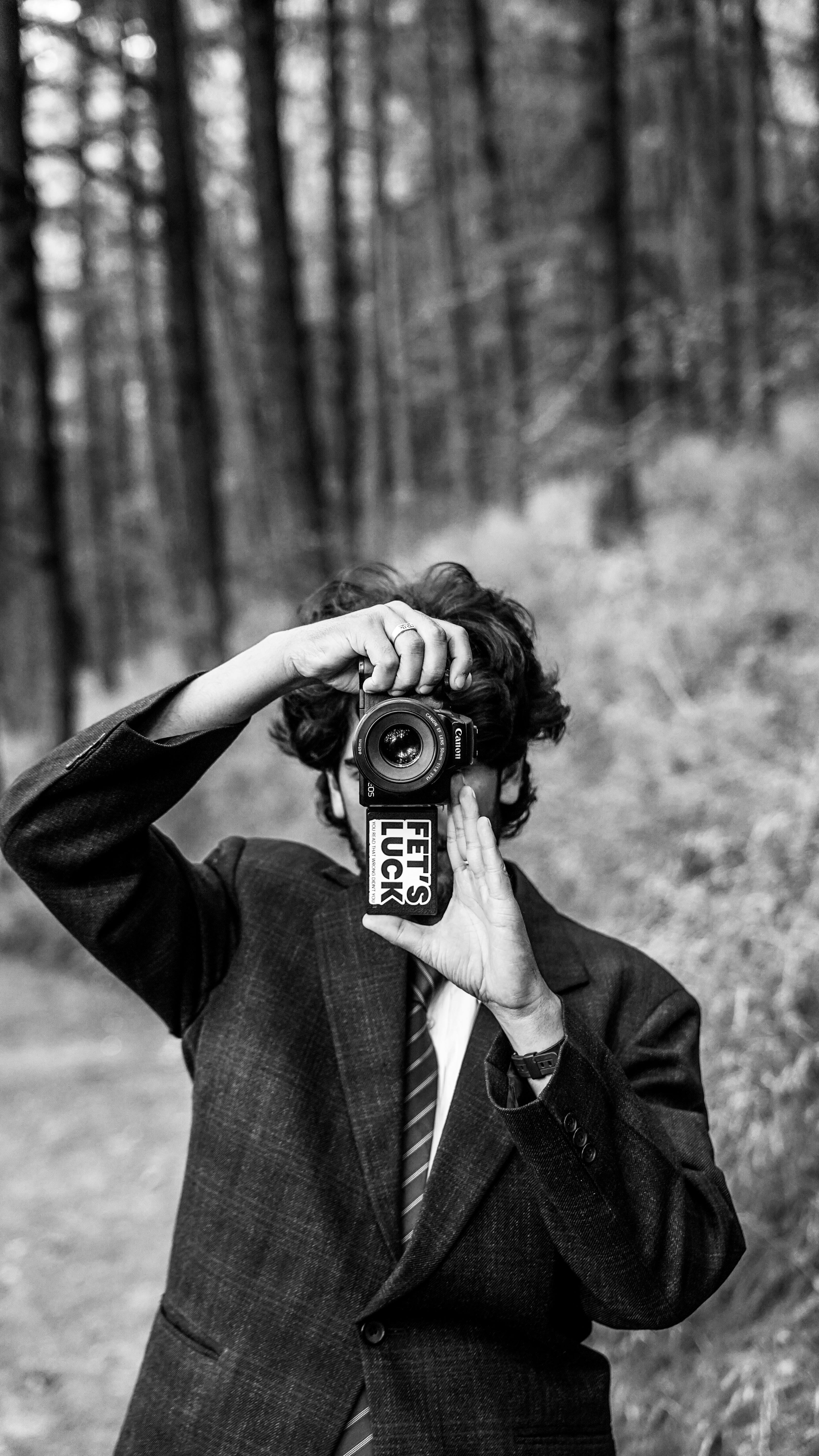 A photographer in Kashmir capturing nature in black and white, showcasing artistic portrait style.