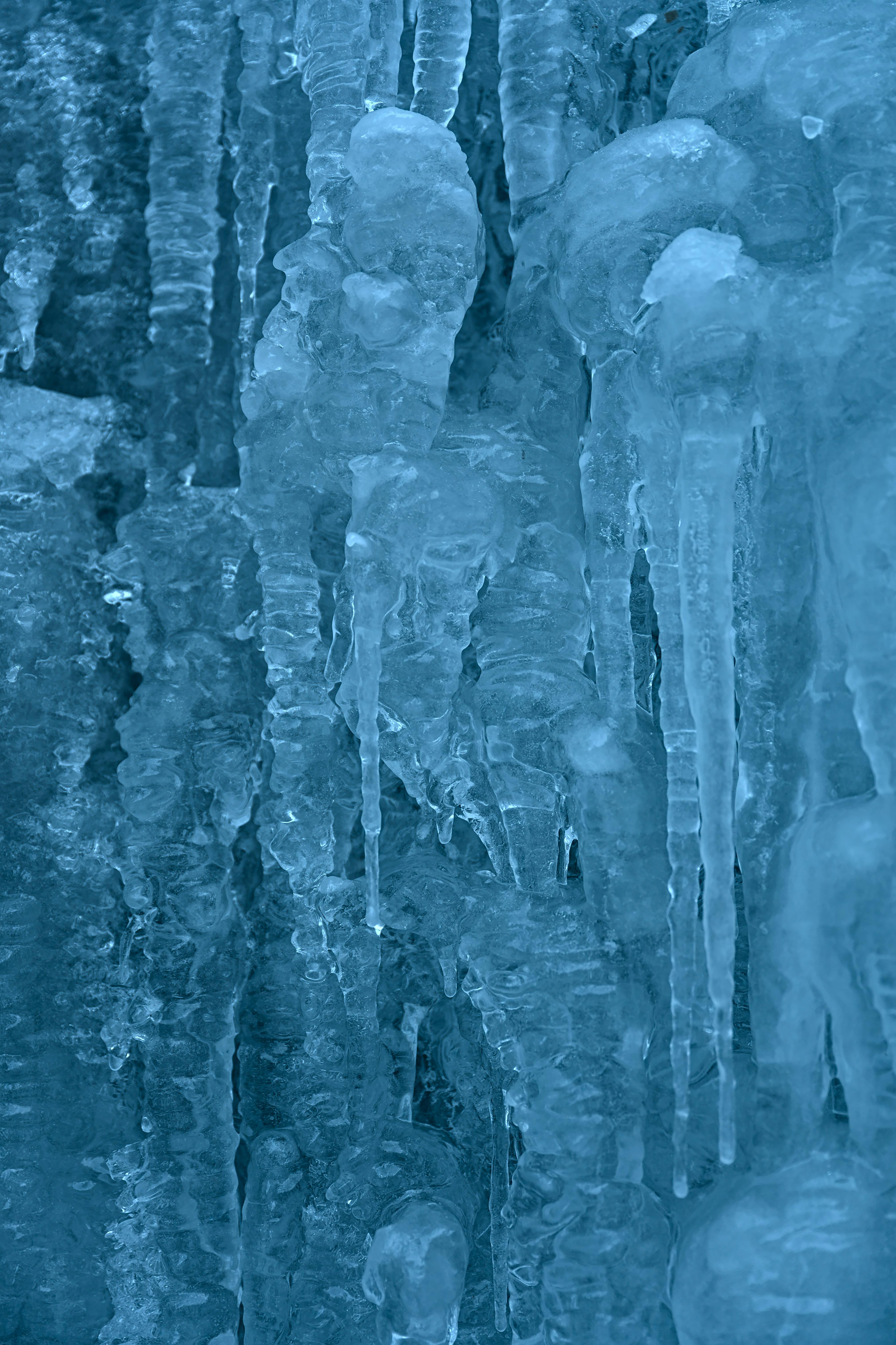Detailed view of icicles with a cool blue tint, capturing the essence of winter.