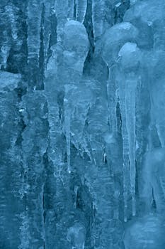 Detailed view of icicles with a cool blue tint, capturing the essence of winter.