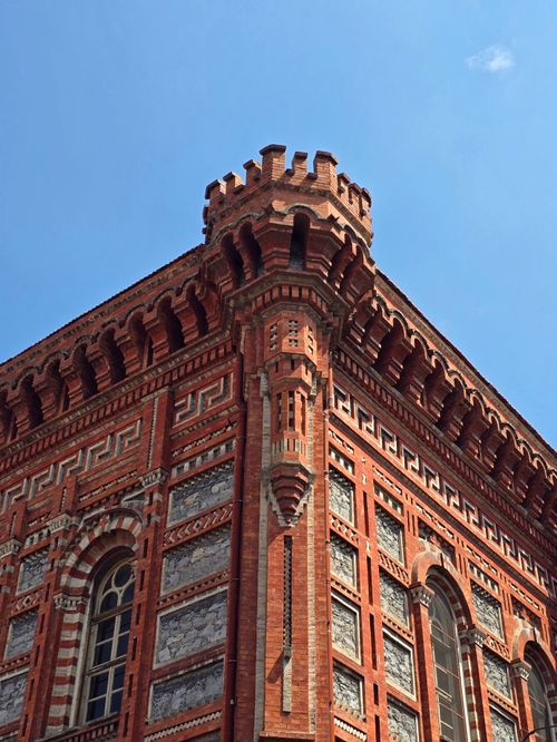 Free Corner view of a red brick Ottoman-era building in Istanbul under a clear blue sky. Stock Photo