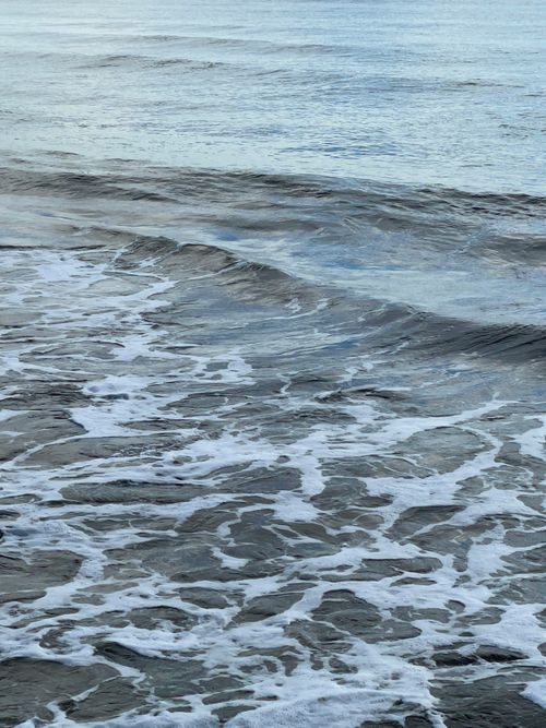 Free Gentle ocean waves create a soothing pattern on a tranquil morning. Stock Photo
