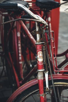 Close-up of vintage red bicycles parked outdoors, showcasing an urban retro design.