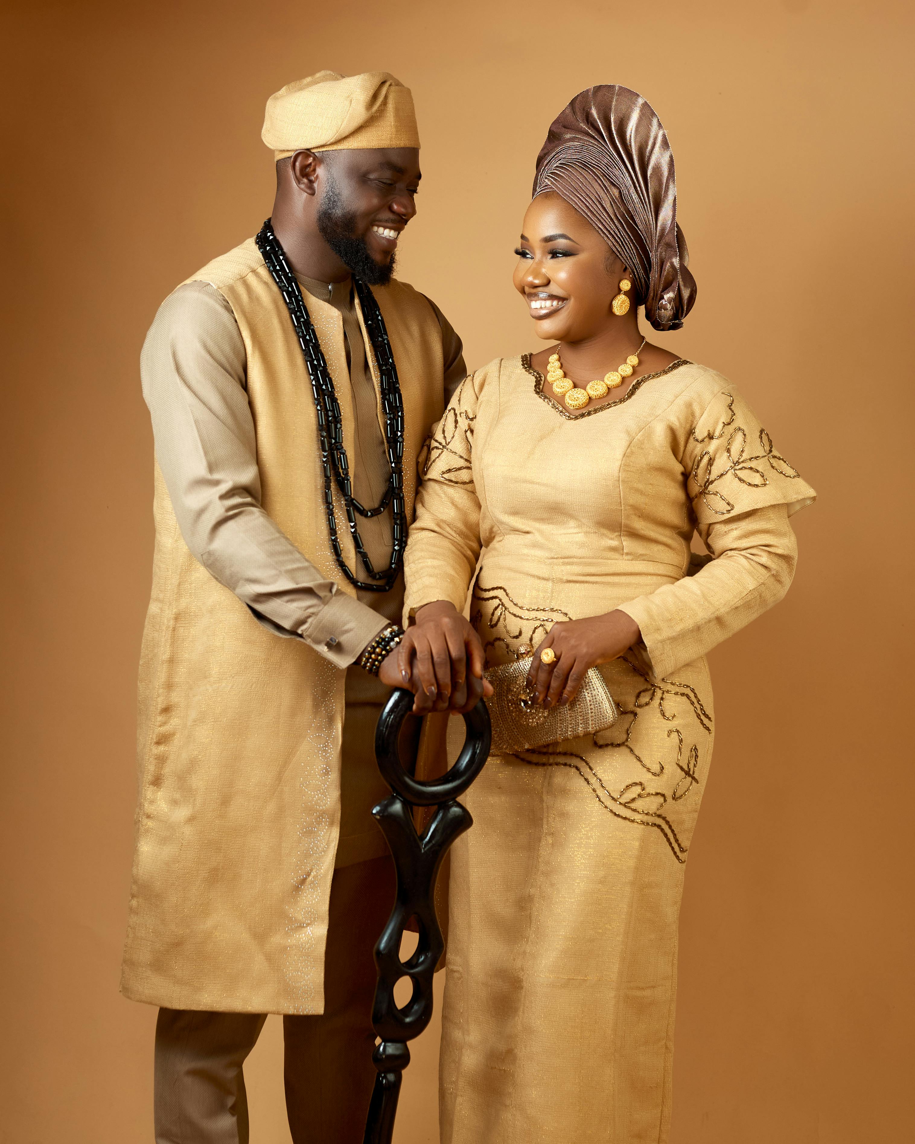 Free Smiling African couple in traditional Nigerian attire, showcasing cultural elegance. Stock Photo