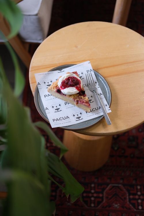 Free A delicious raspberry tart with cream on a plate at a cozy café in Istanbul. Stock Photo