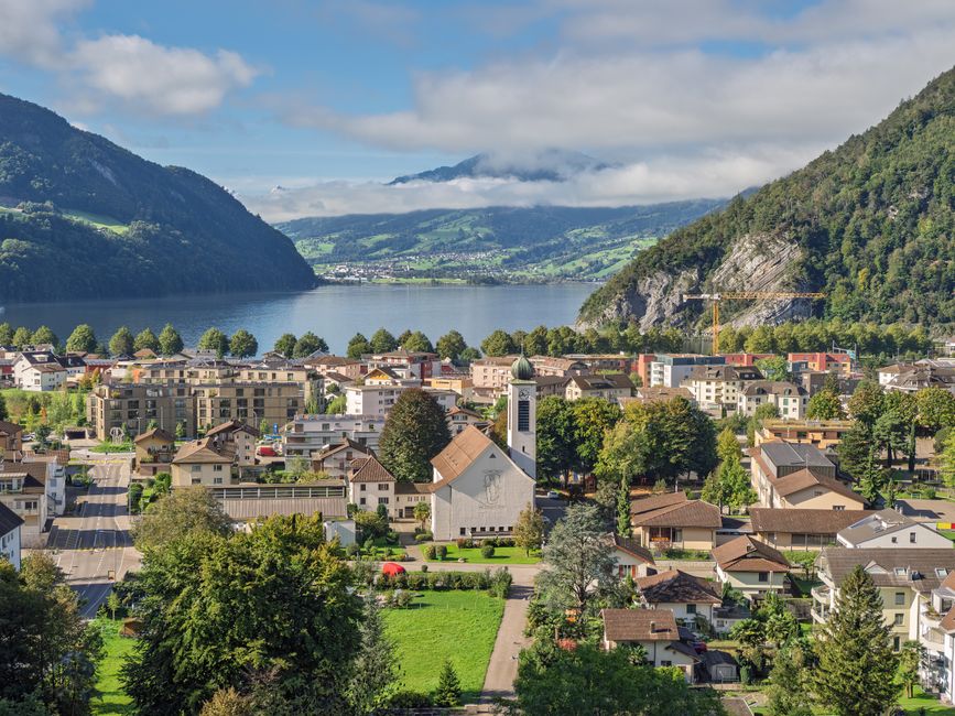 Breathtaking Swiss Capital City Helicopter Sightseeing Tour - The Ideal Flight to See Berne Review Review 2026 - A picturesque town beside a Swiss lake, nestled between verdant hills and mountains.