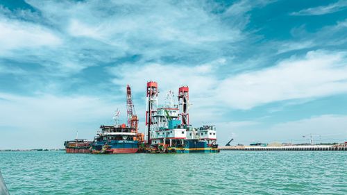 Free Colorful industrial ships at harbor, vibrant cranes under a bright sky. Stock Photo