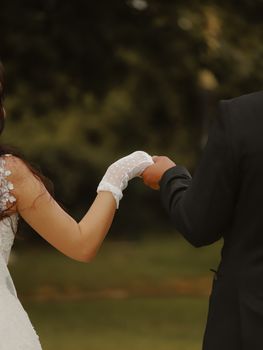 Bride and groom hold hands in a beautiful outdoor wedding in Antalya, Türkiye.
