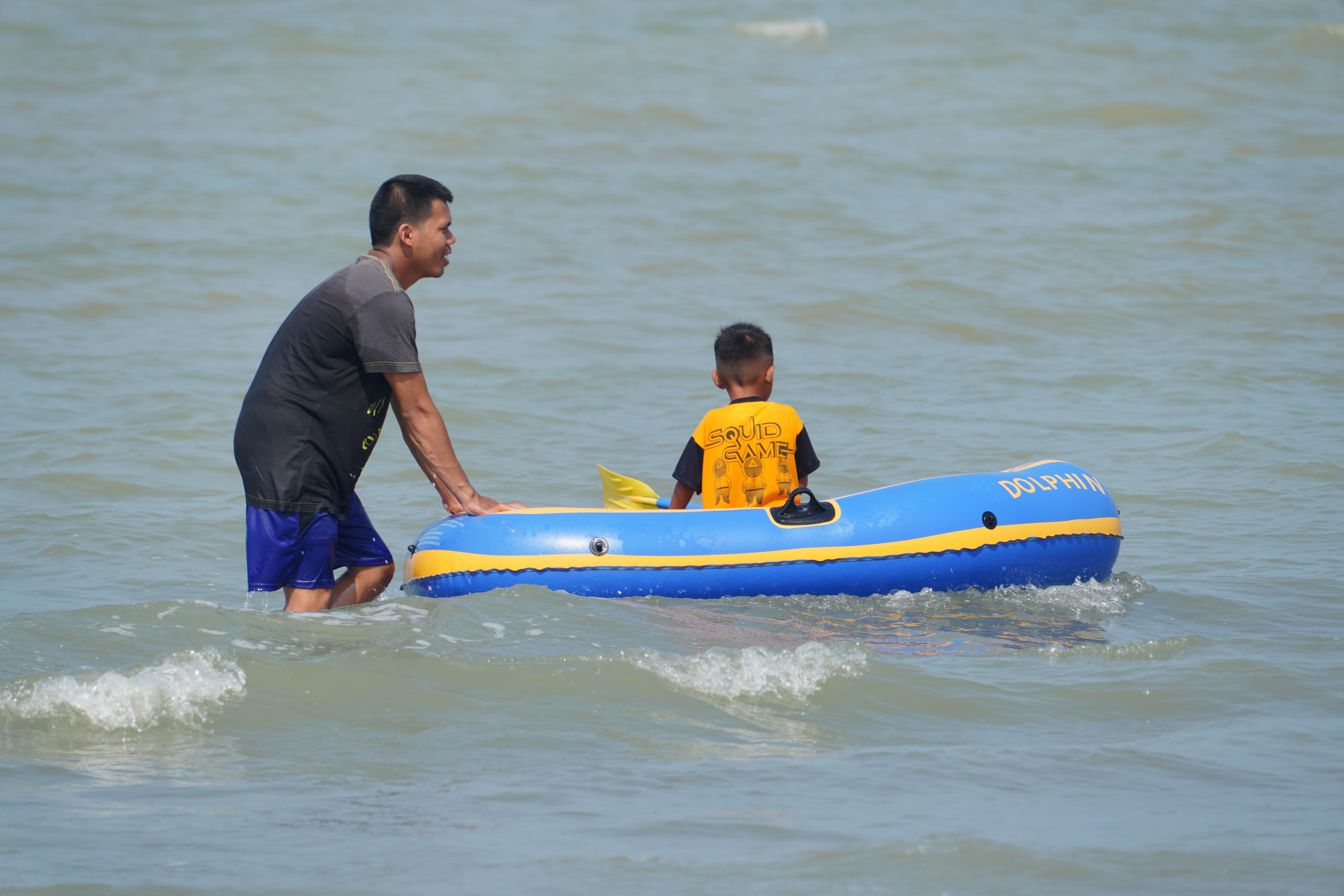 Father and Son Enjoy Inflatable Boat Ride at Sea · Free Stock Photo