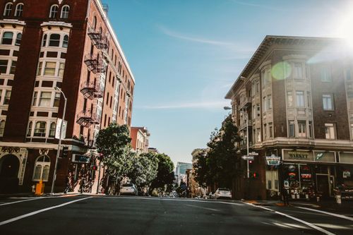 Free Charming urban street with historic buildings and vibrant daytime atmosphere. Stock Photo