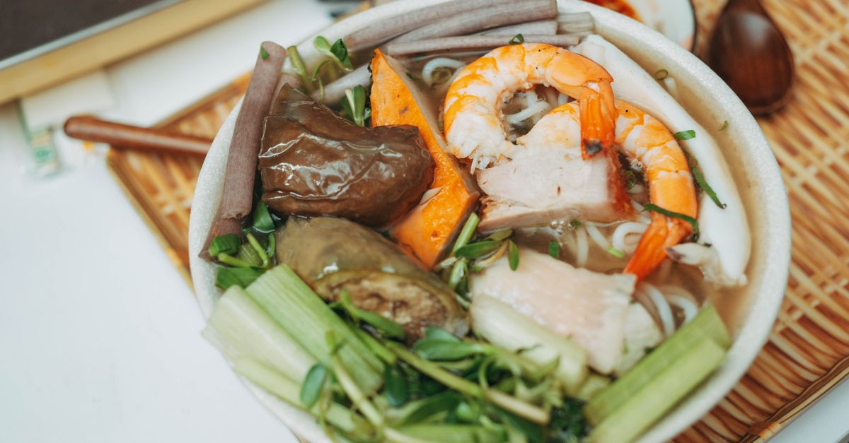 A healthy Vietnamese bowl with spiralized vegetables, fresh herbs, and a clear broth