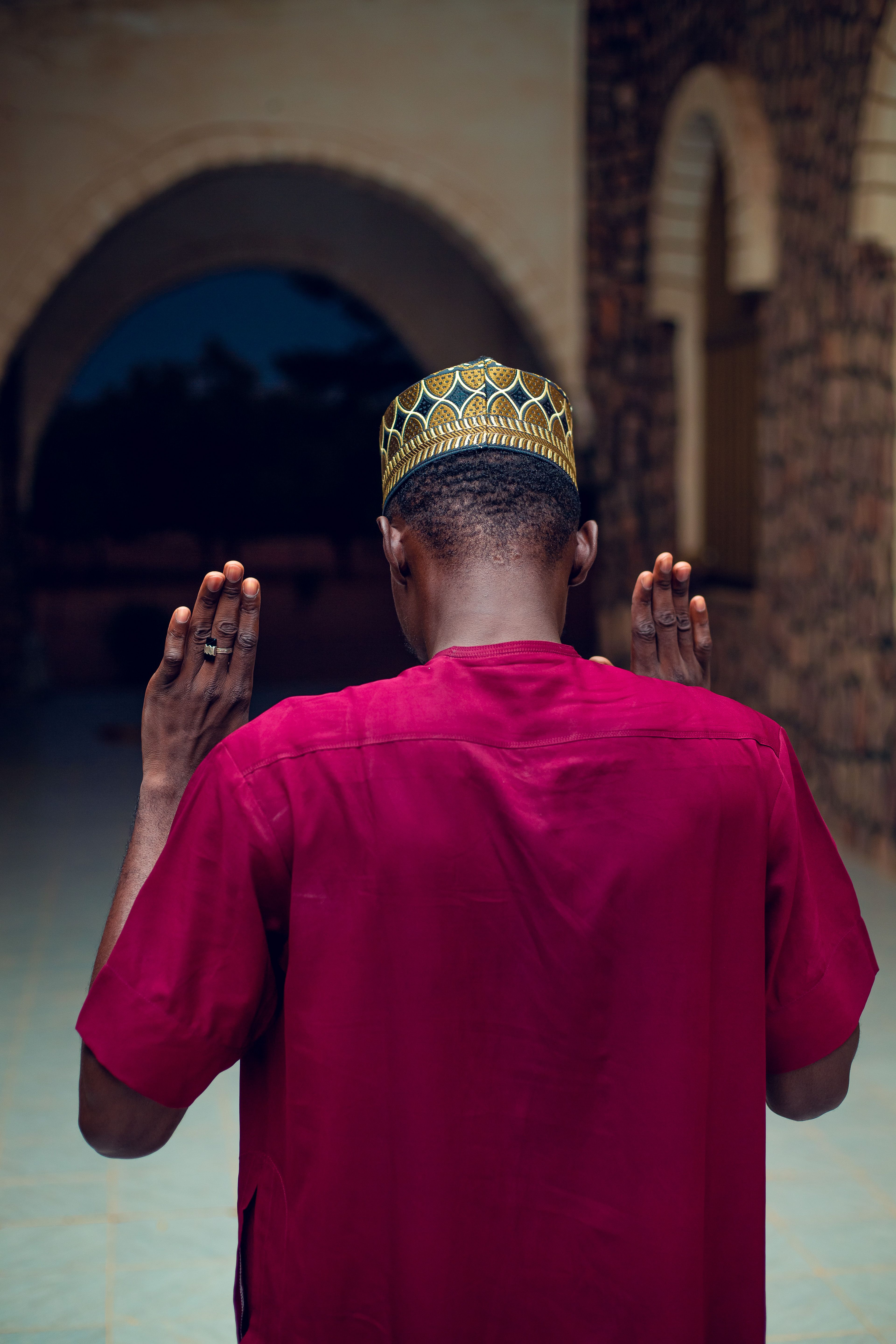 Man in Traditional Attire Praying Outdoors · Free Stock Photo