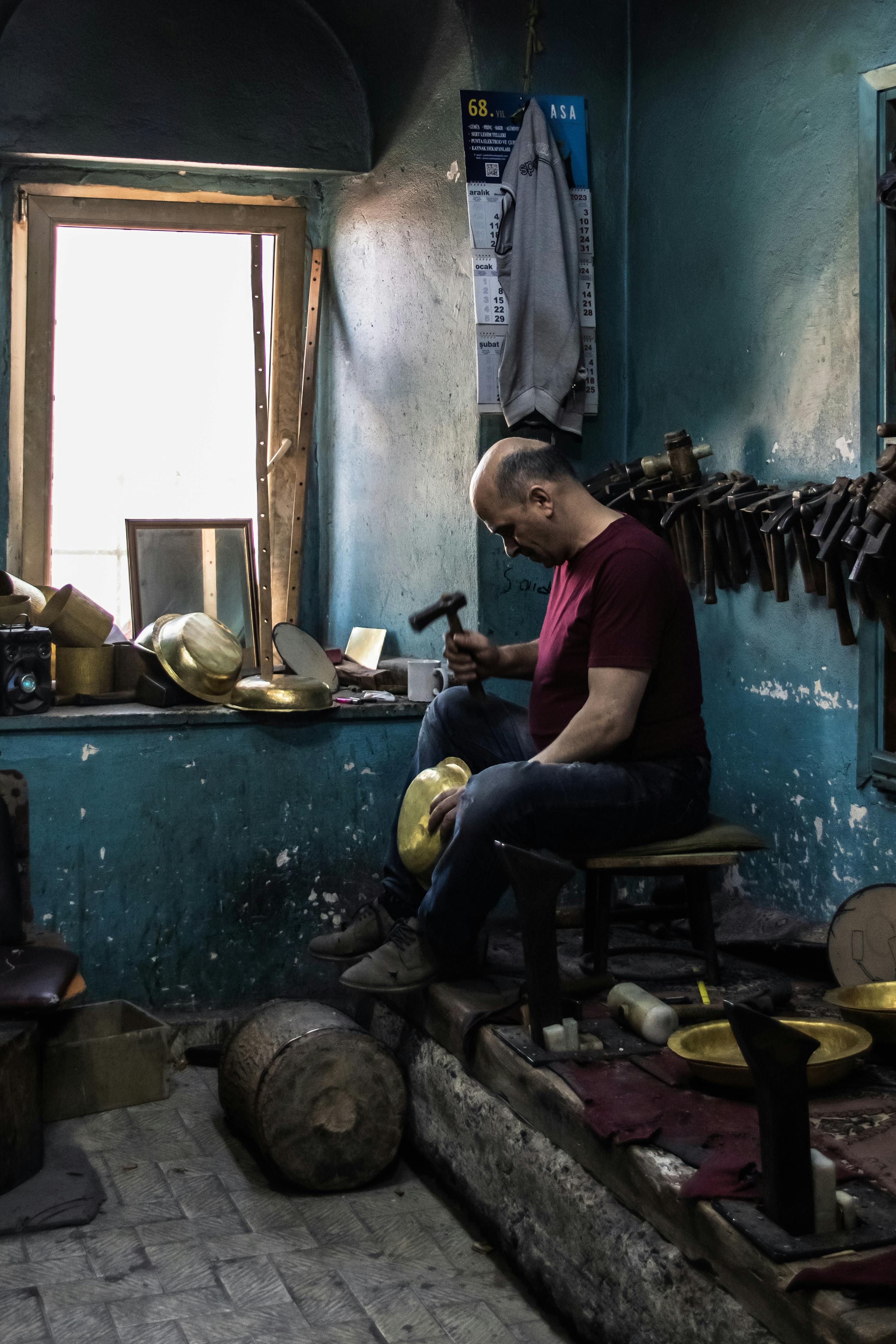 Metal craftsman working in a traditional workshop