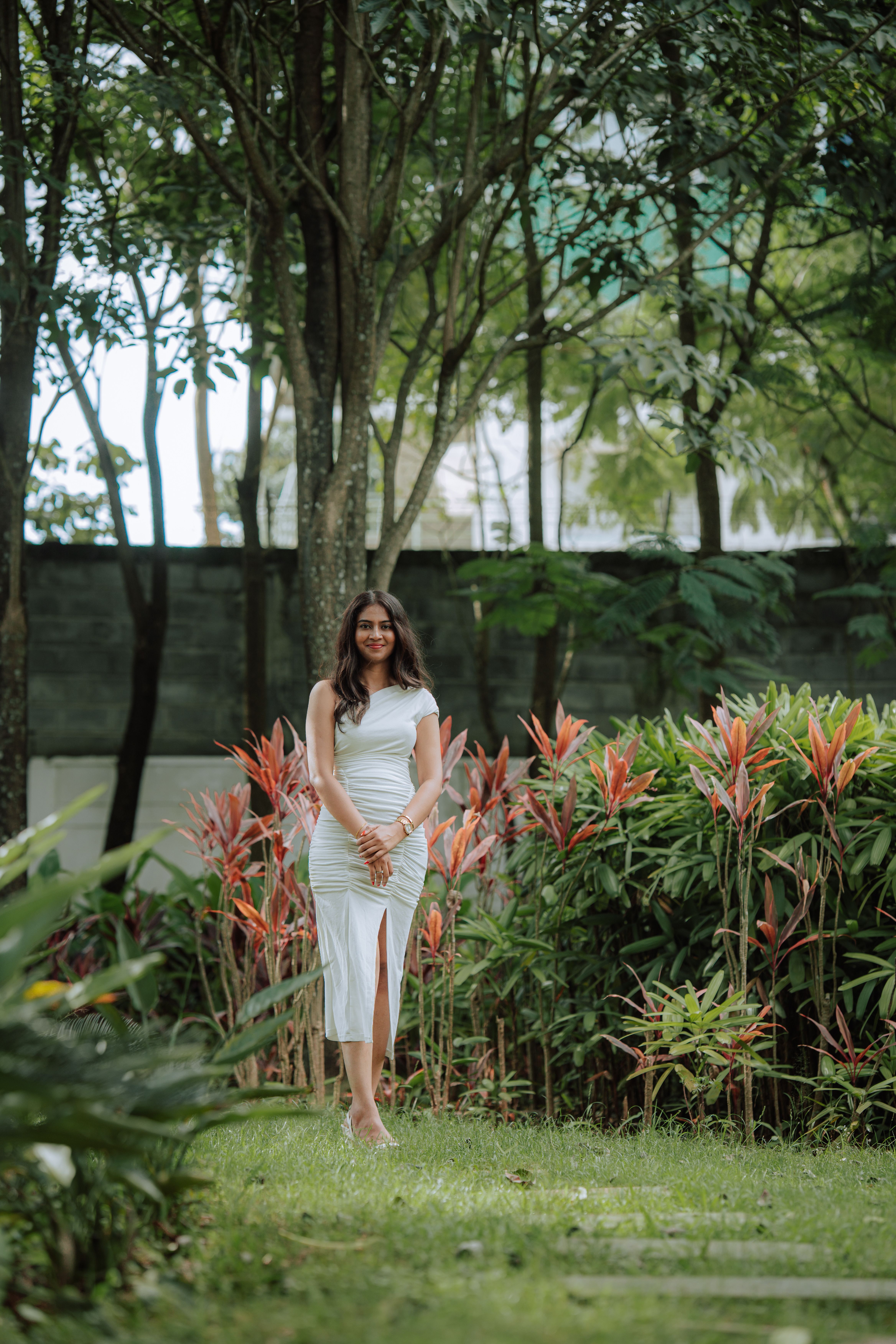 Elegant Woman Posing Outdoors in Tropical Setting · Free Stock Photo