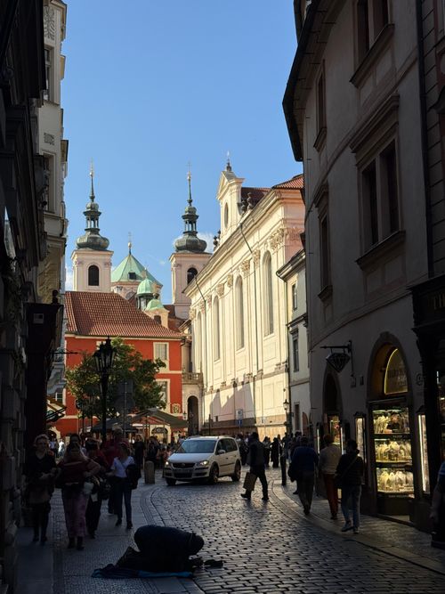 Free A bustling street in Prague's historic Old Town with Baroque architecture and street life. Stock Photo
