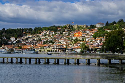 Free Picturesque Ohrid town with a Macedonian flag overlooking the lake and pier. Stock Photo