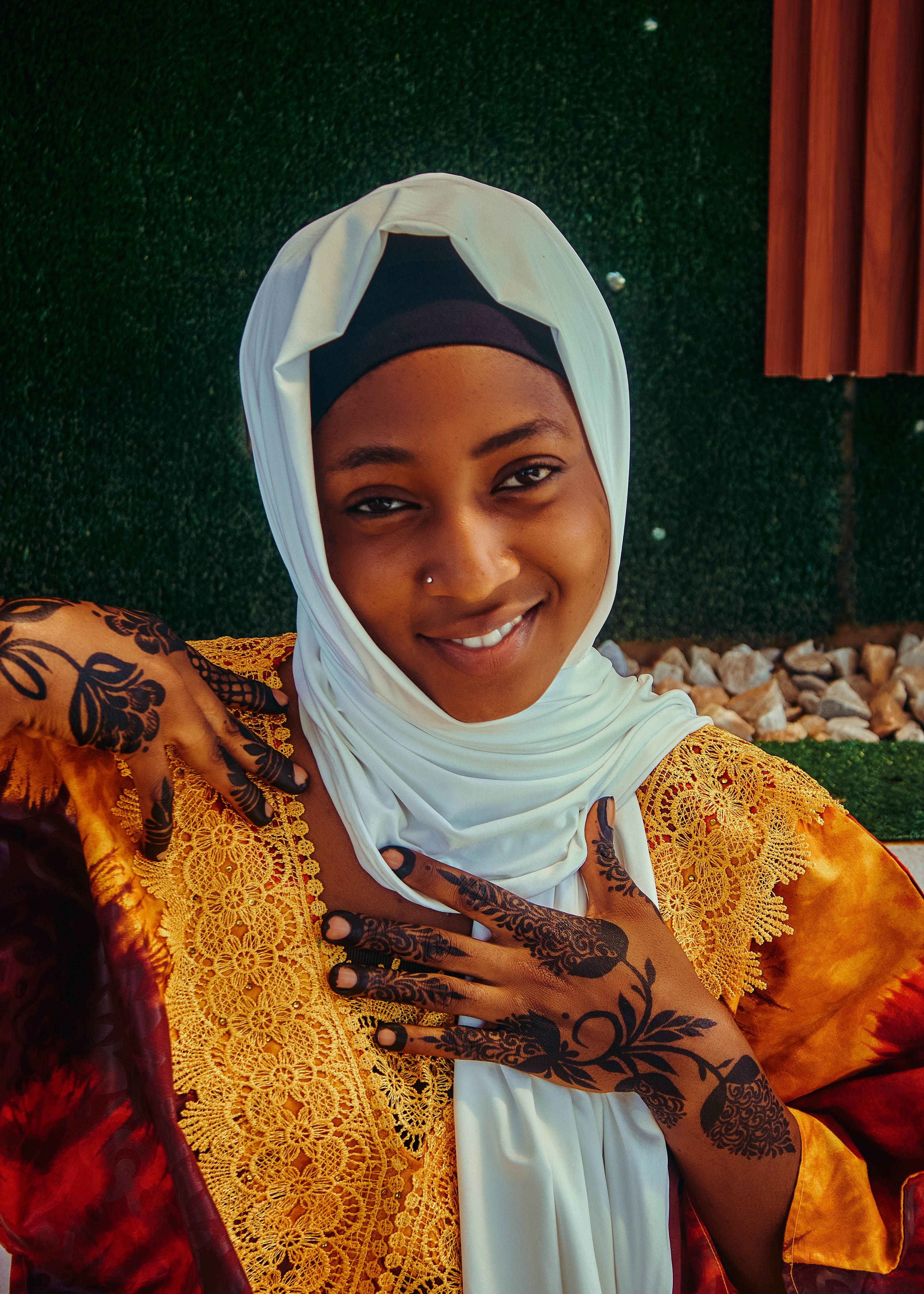 Portrait of a Smiling Woman in Traditional Attire · Free Stock Photo