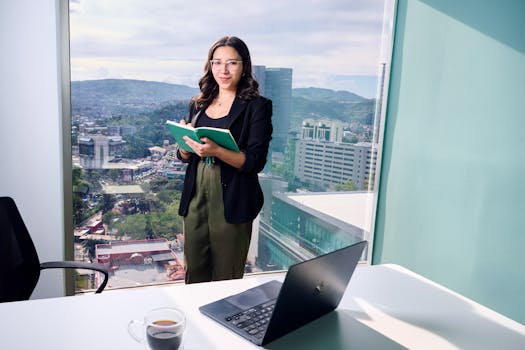 Businesswoman in office holding notebook by window overlooking cityscape.