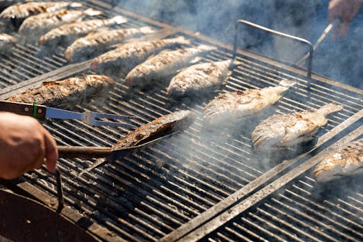 Delicious fish grilling on a barbecue in Ivanić-Grad, Croatia, with smoky flavors and sunny outdoor ambiance.