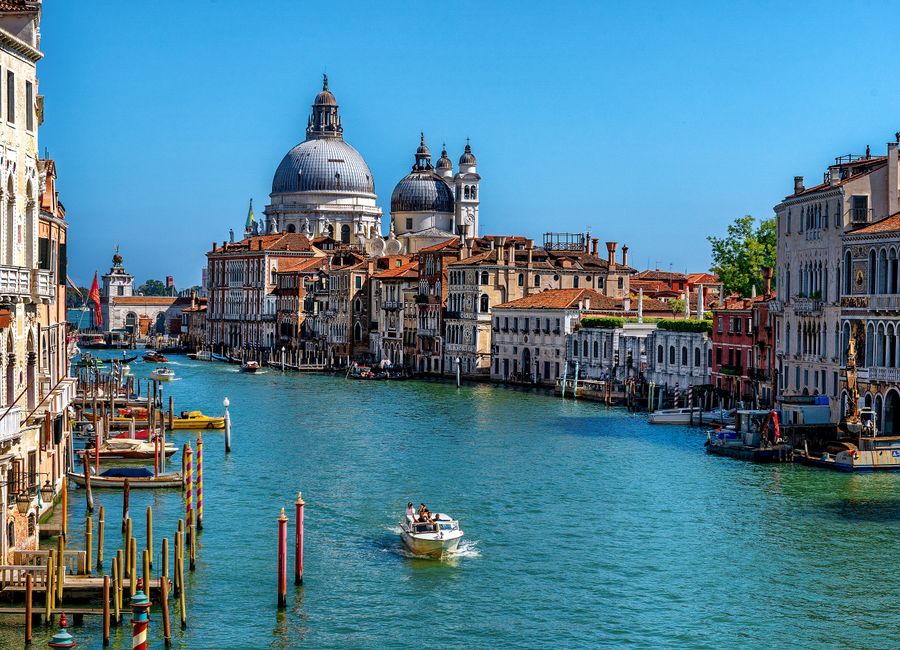 Stunning daytime view of the Grand Canal in Venice, featuring gondolas and historic architecture.