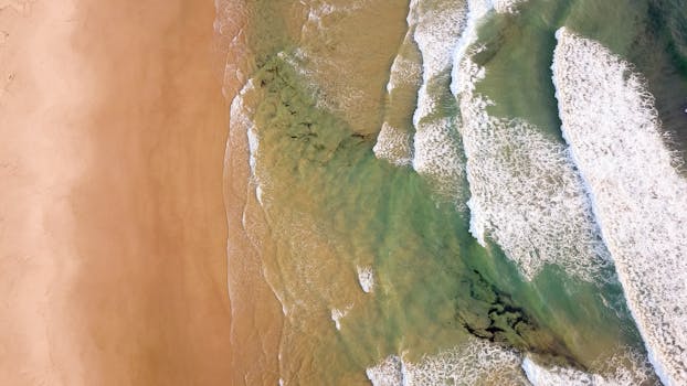 Stunning aerial view of waves crashing at Crescent Head Beach, Australia.