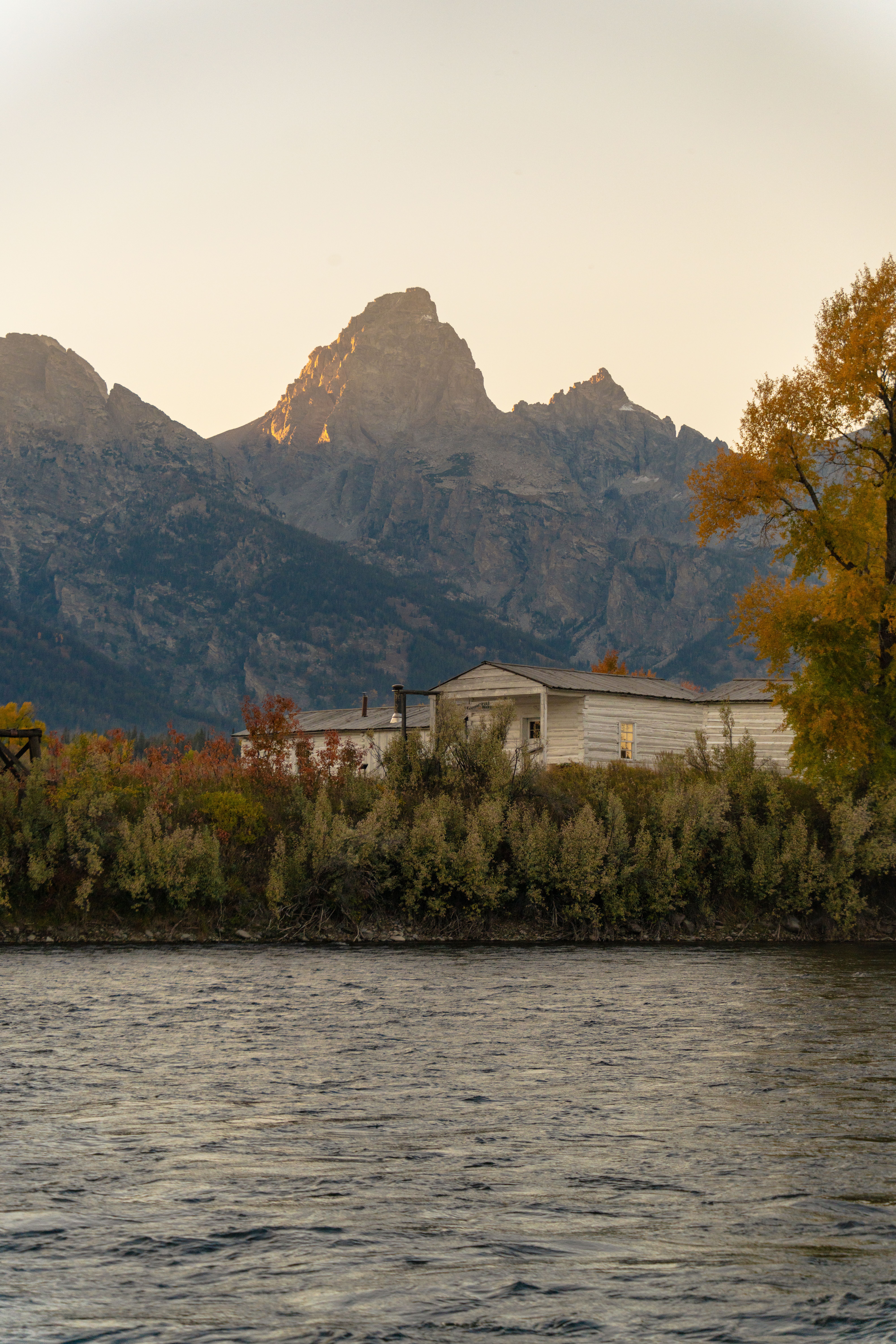 An RV parked near colorful autumn trees at a quiet campground