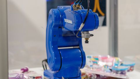 A blue Yaskawa industrial robot arm on display, showcasing advanced technology and robotics.