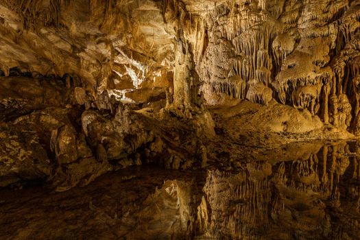 Explore the mystical beauty of Prometheus Cave in Georgia, featuring striking stalactites and natural reflections.