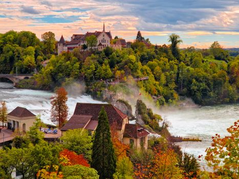 Experience the vivid autumn colors surrounding Rheinfall in Neuhausen am Rheinfall, Switzerland.