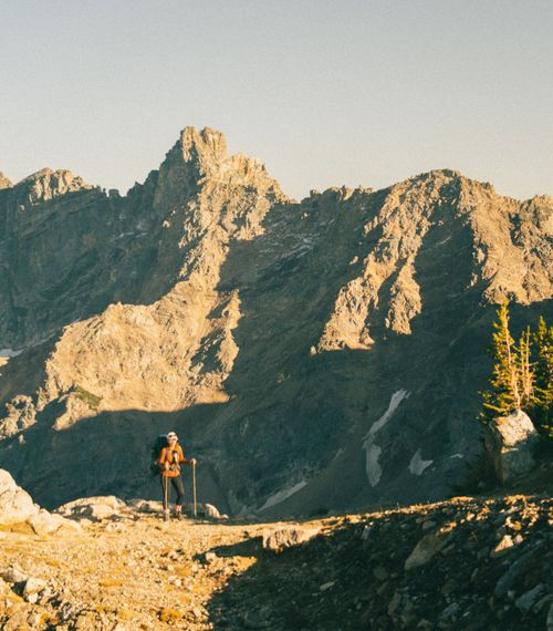 Free A lone hiker explores the rugged terrain of Grand Teton National Park, Wyoming, during fall. Stock Photo