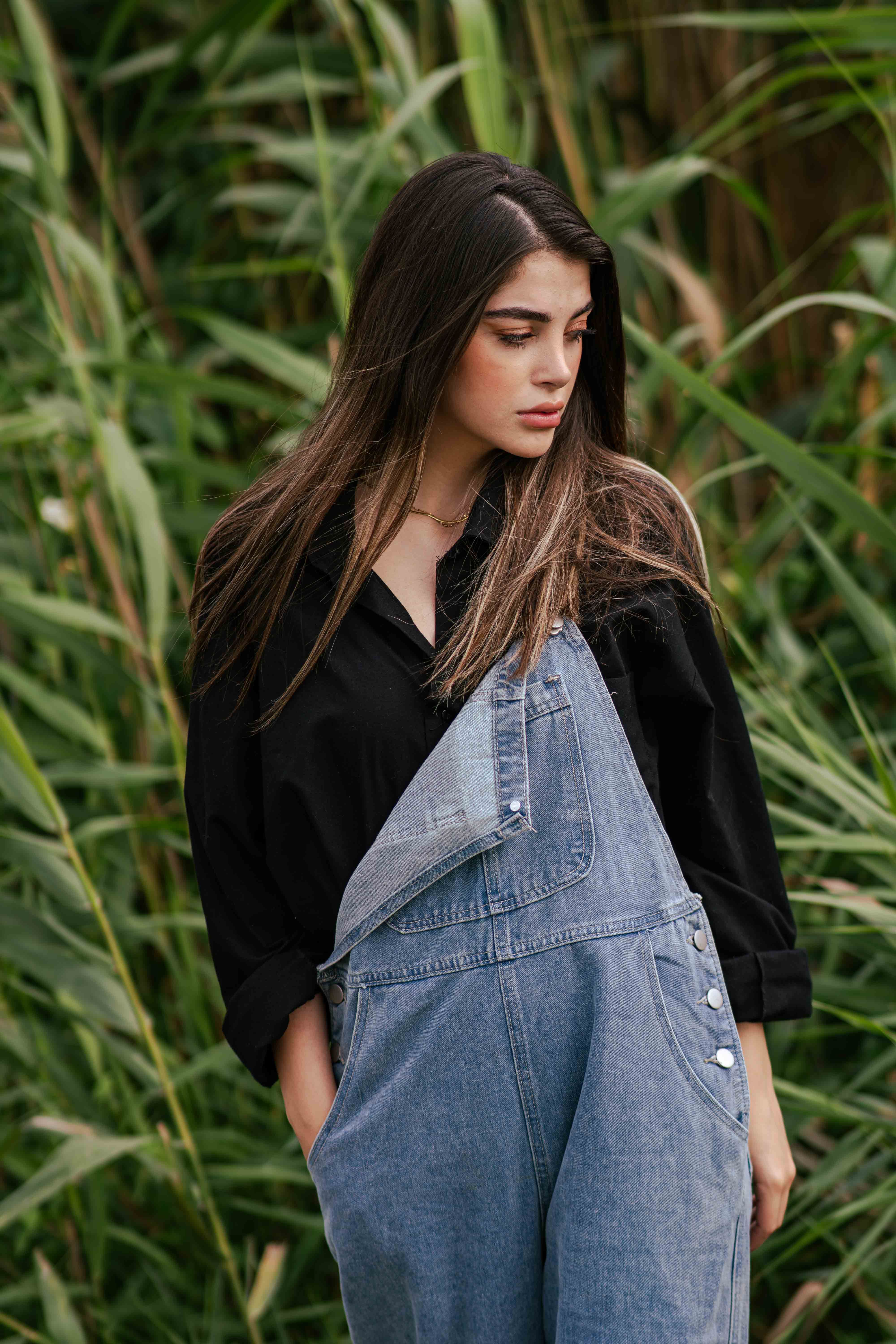 Woman wearing a pinafore dress with a t-shirt