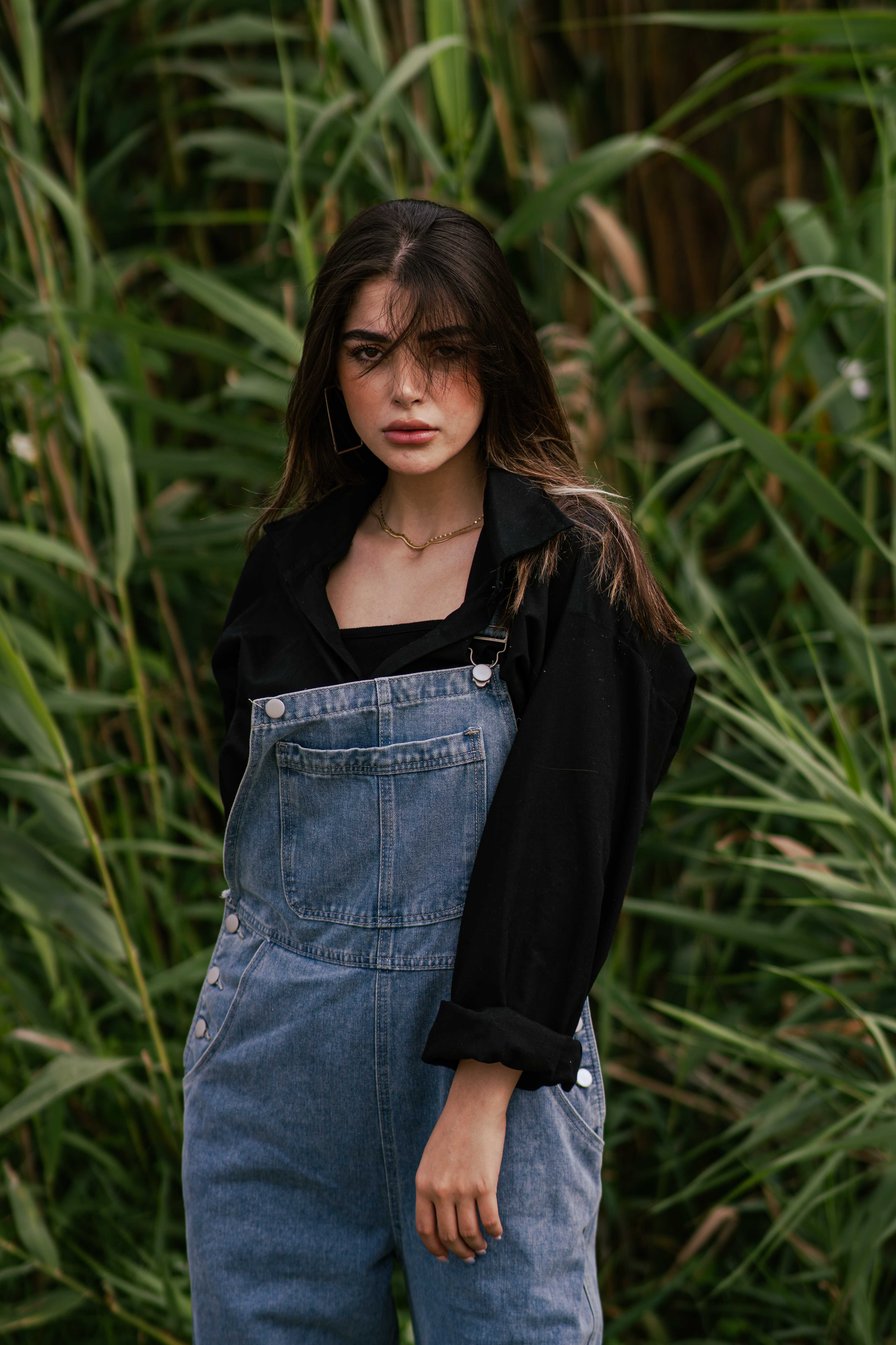 Portrait of a Woman in Denim Overalls Outdoors · Free Stock Photo