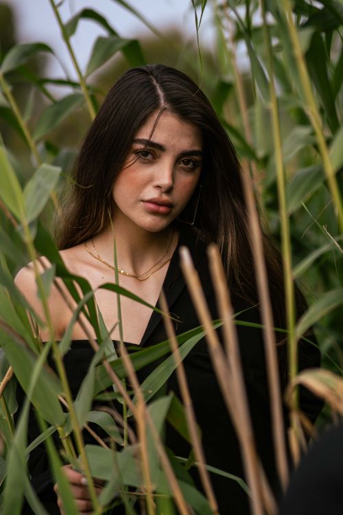 Free Striking portrait of a woman surrounded by lush greenery in Bandar Gaz, Iran. Stock Photo