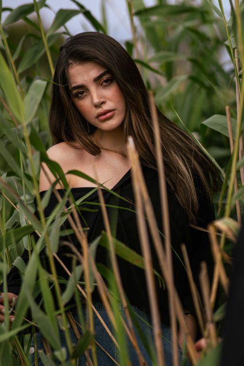 Free Captivating portrait of a woman surrounded by lush greenery in Bandar Gaz, Iran. Stock Photo
