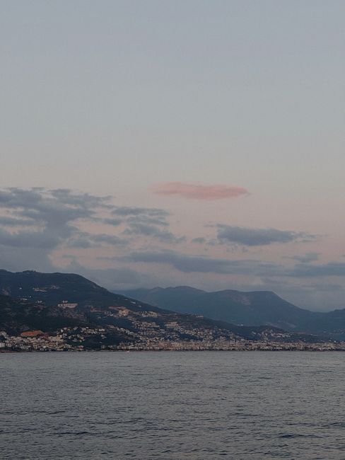 Stunning twilight view of a Turkish coastline with mountains and sea.