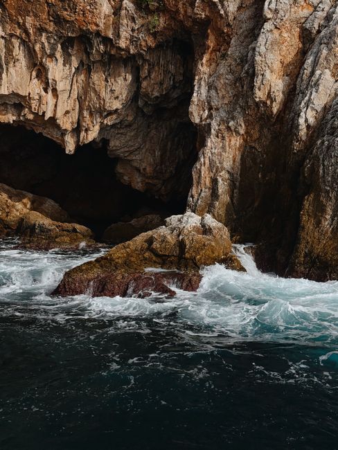 A stunning sea cave with crashing waves along the rocky Turkish coastline, showcasing nature's raw beauty.