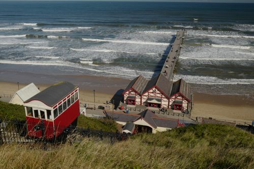 Free A scenic aerial view of Saltburn-by-the-Sea featuring the cliff tramway, beach, and pier. Stock Photo