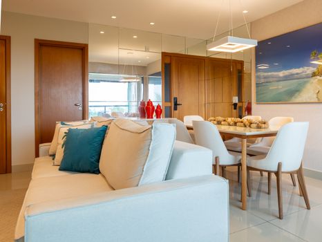 Stylish living room in Salvador, Brazil featuring modern decor, cozy furniture, and vibrant accents.