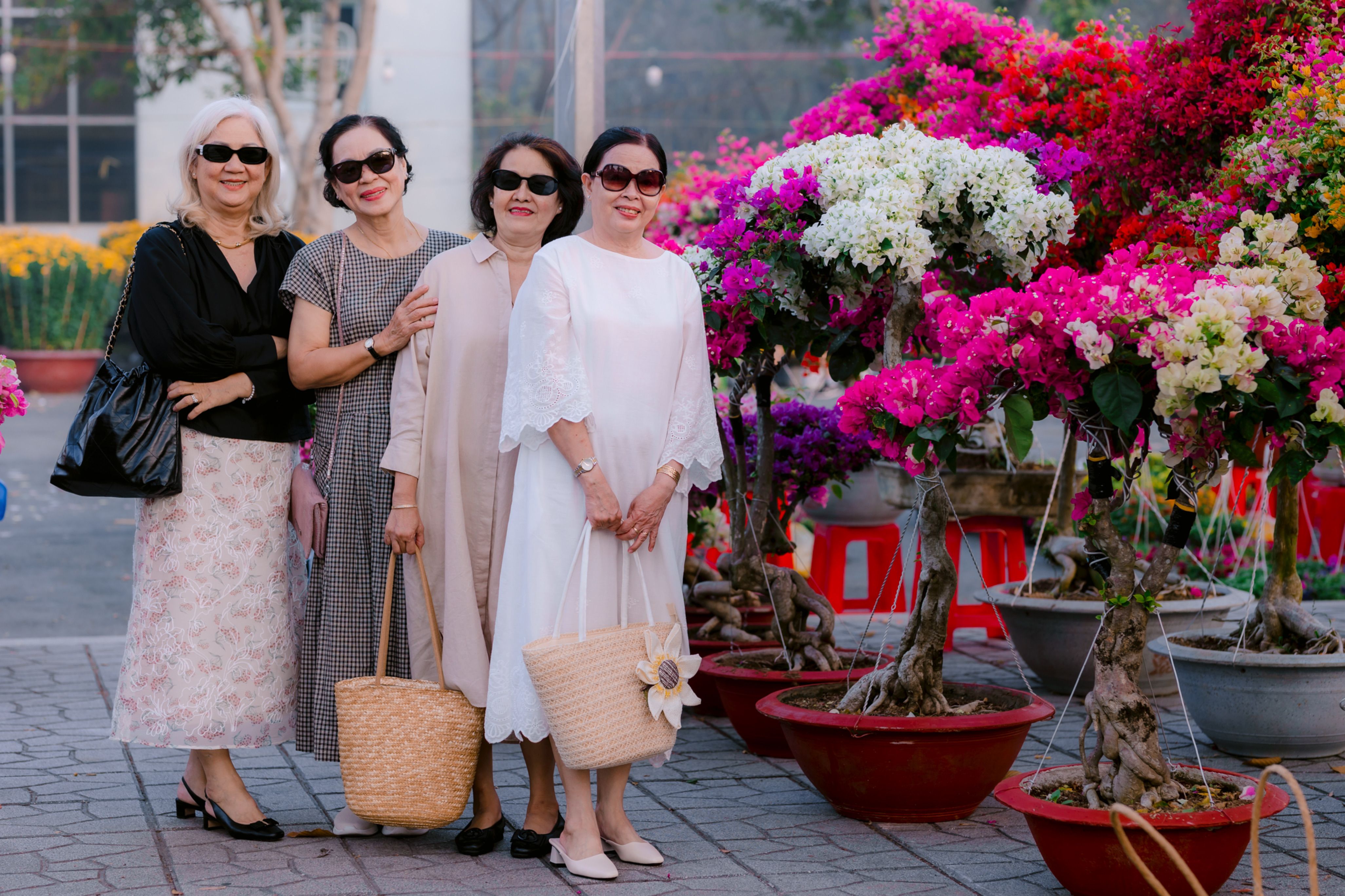 Elegant Senior Women Posing with Vibrant Flowers · Free Stock Photo