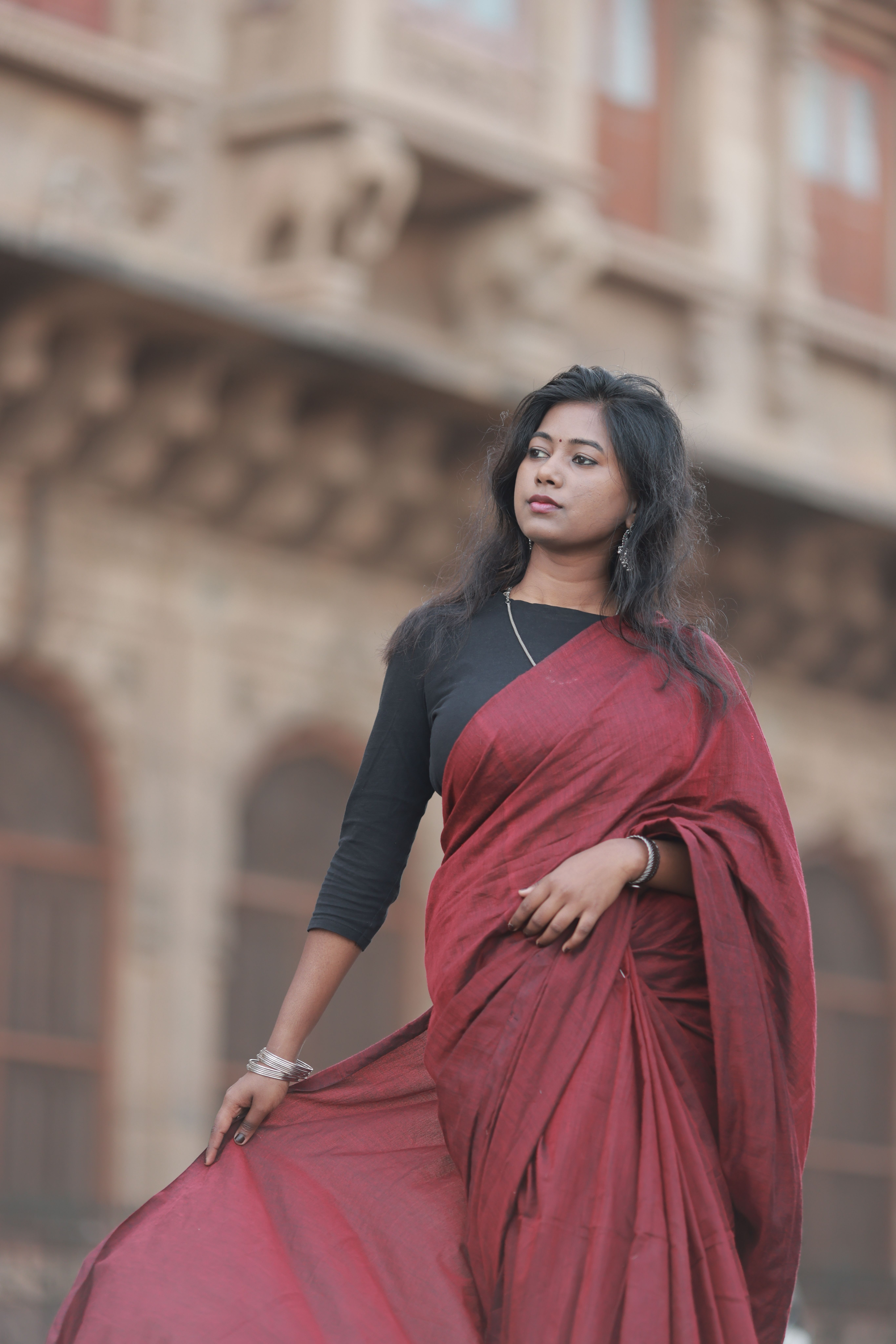Elegant Woman in Red Saree with Historic Background · Free Stock Photo