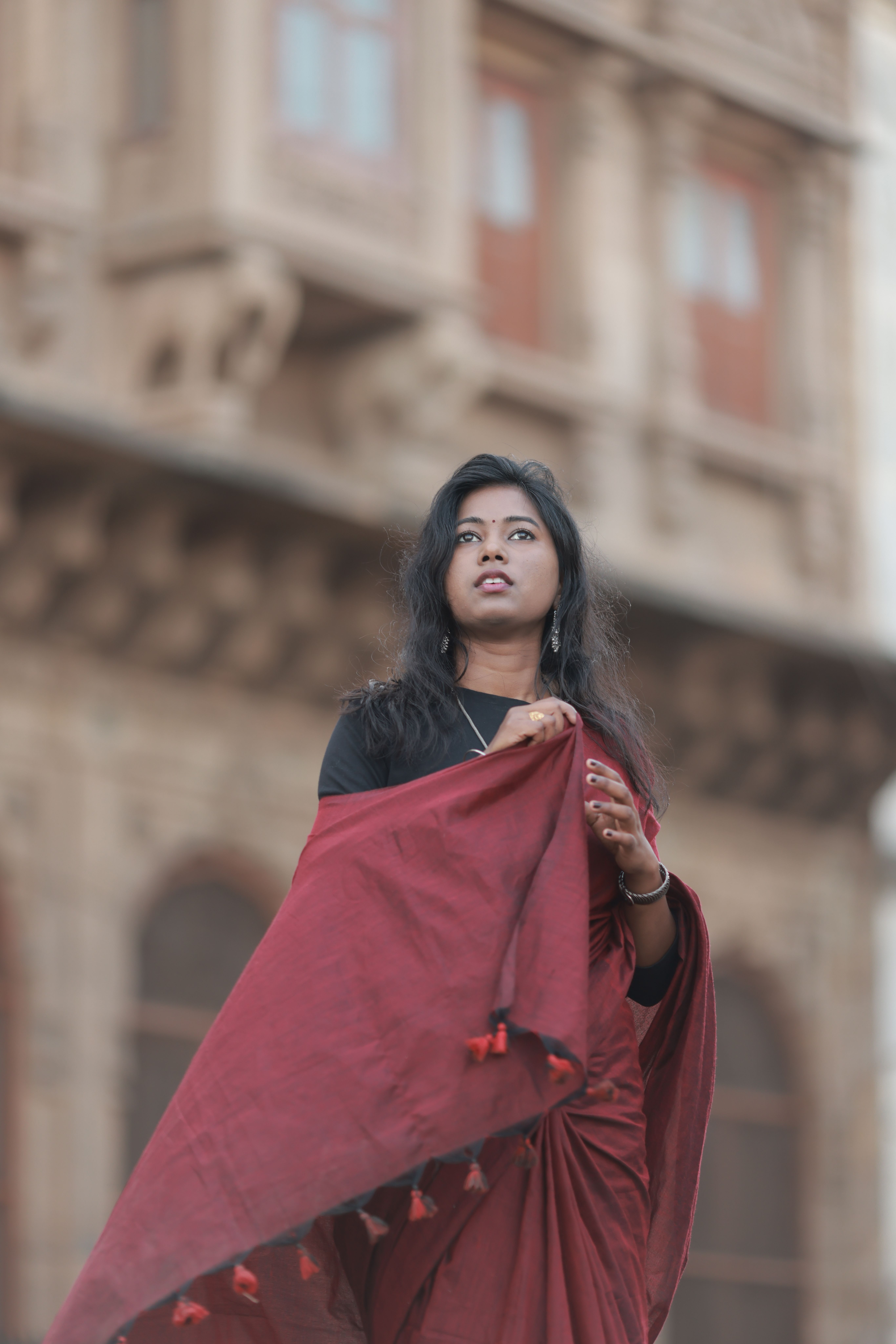 Elegant Woman in Red Saree with Historic Background · Free Stock Photo