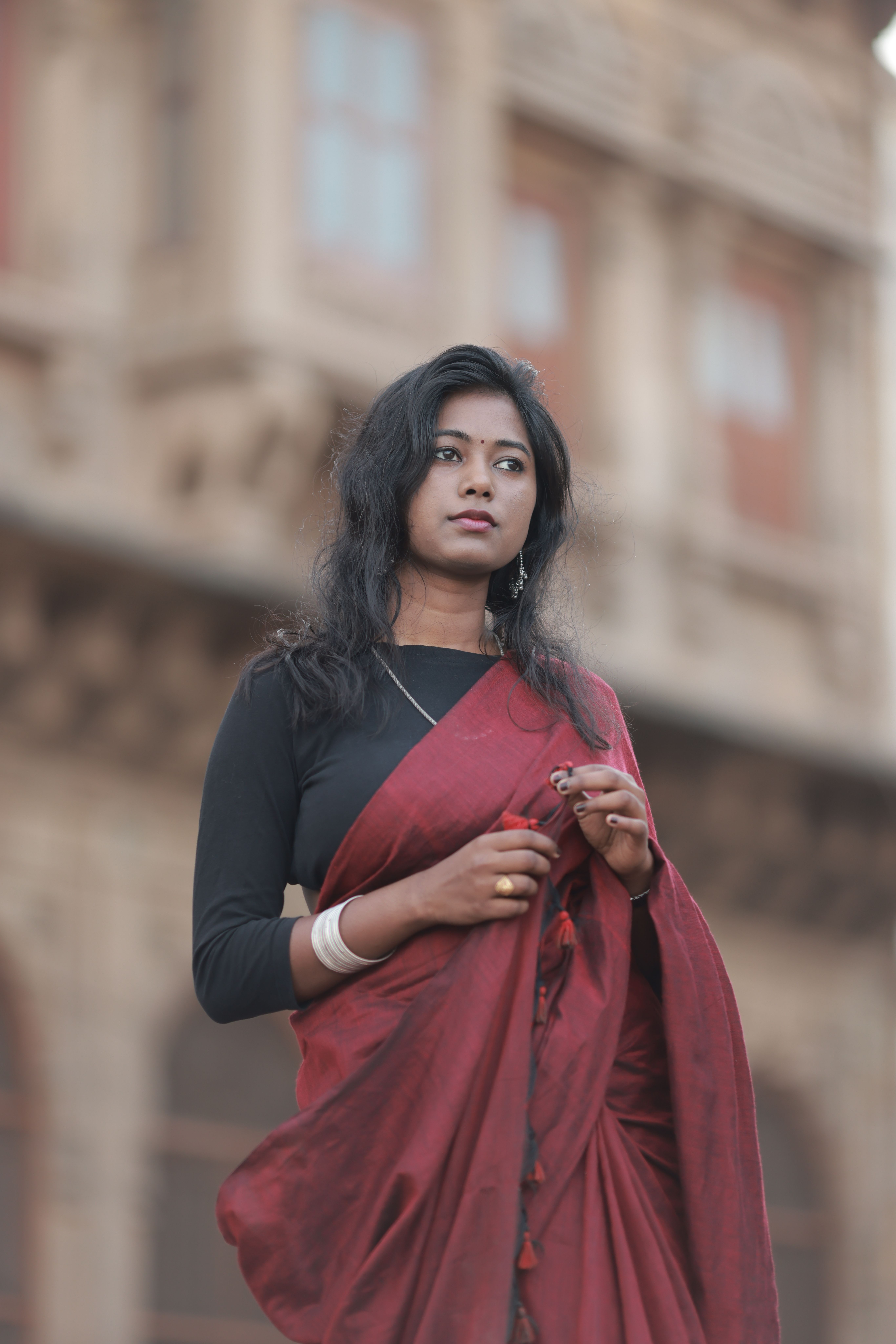 Elegant Woman in Red Saree with Historic Background · Free Stock Photo