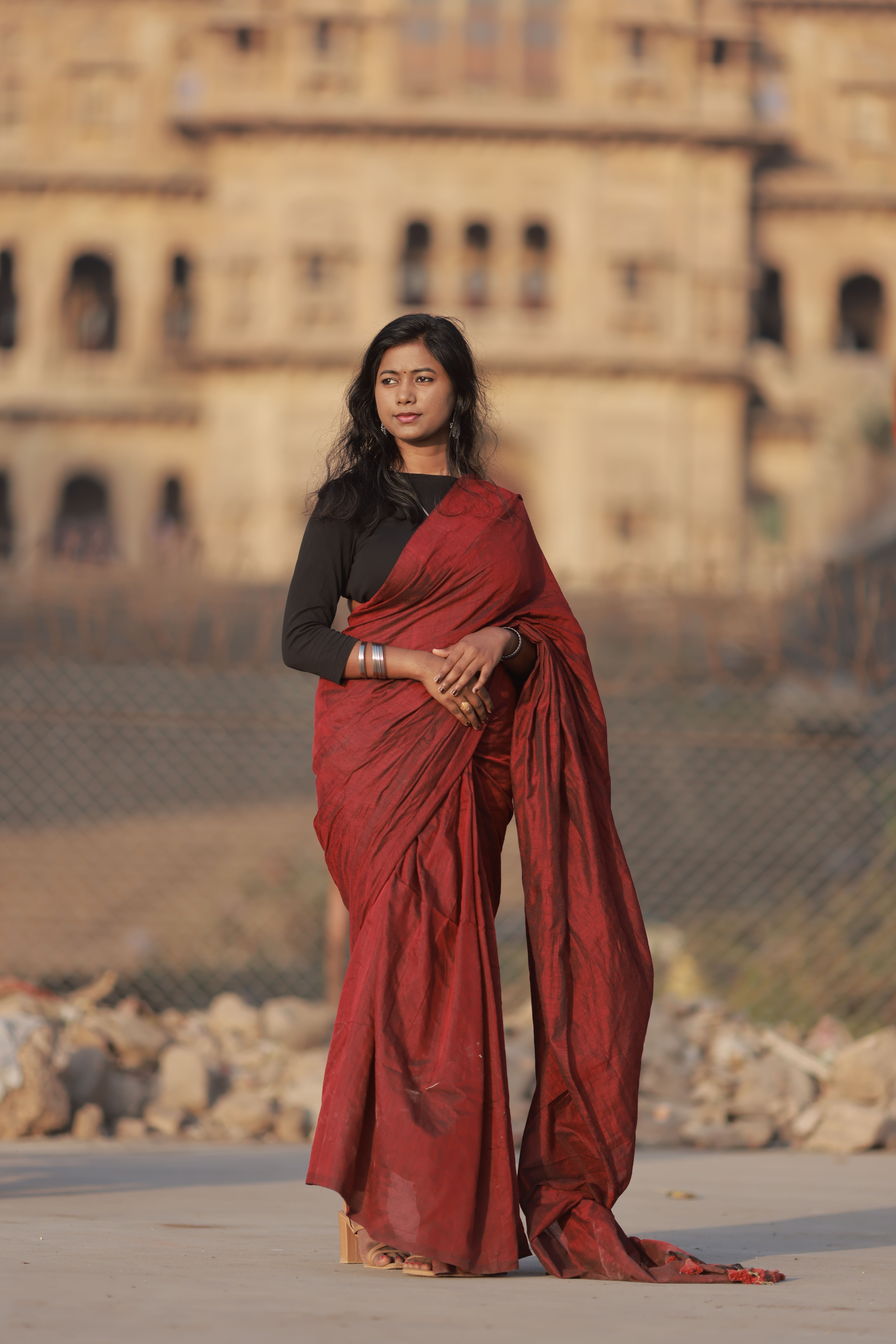 Elegant Woman in Red Saree with Historic Background · Free Stock Photo
