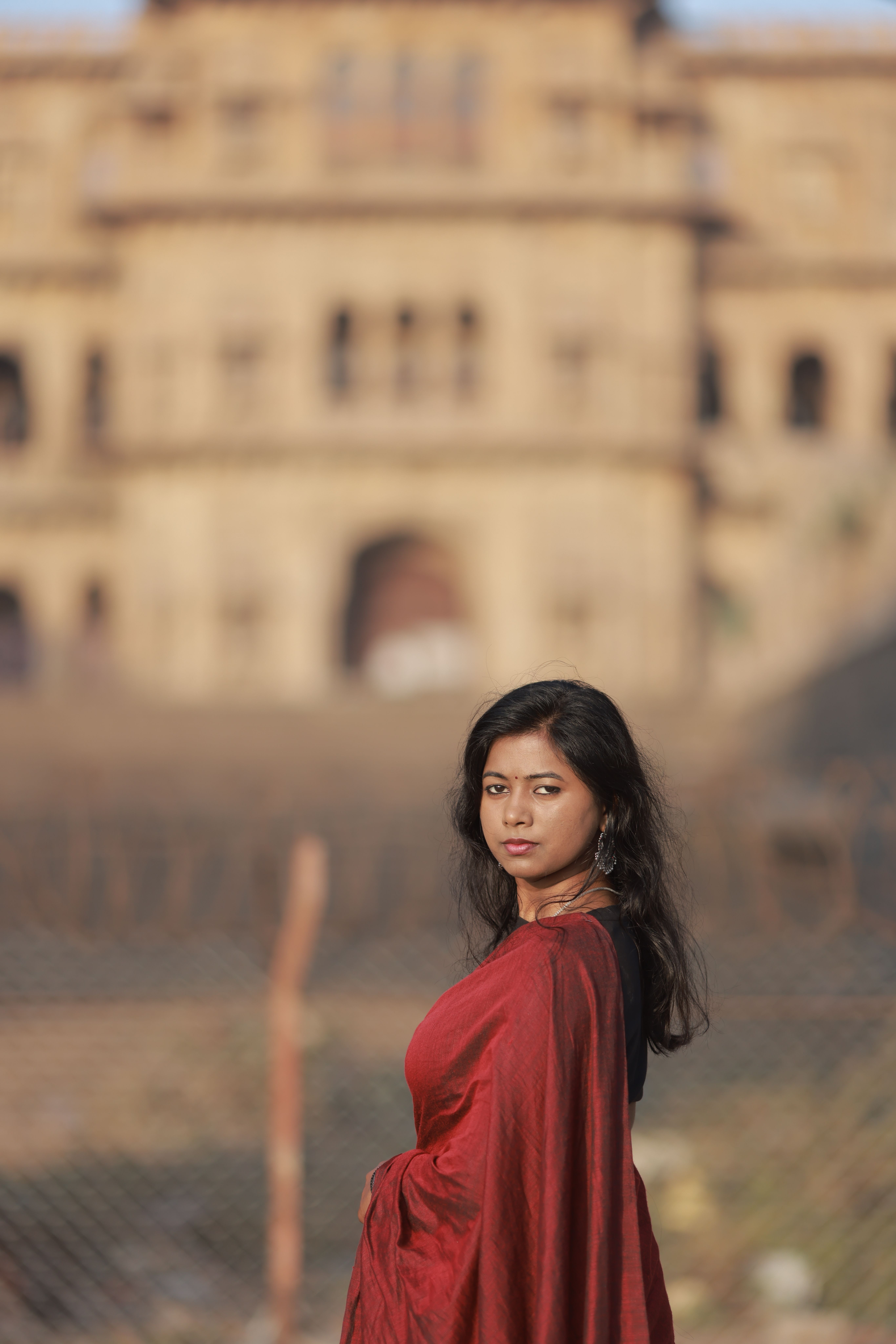 Elegant Woman in Red Sari Posing Outdoors · Free Stock Photo