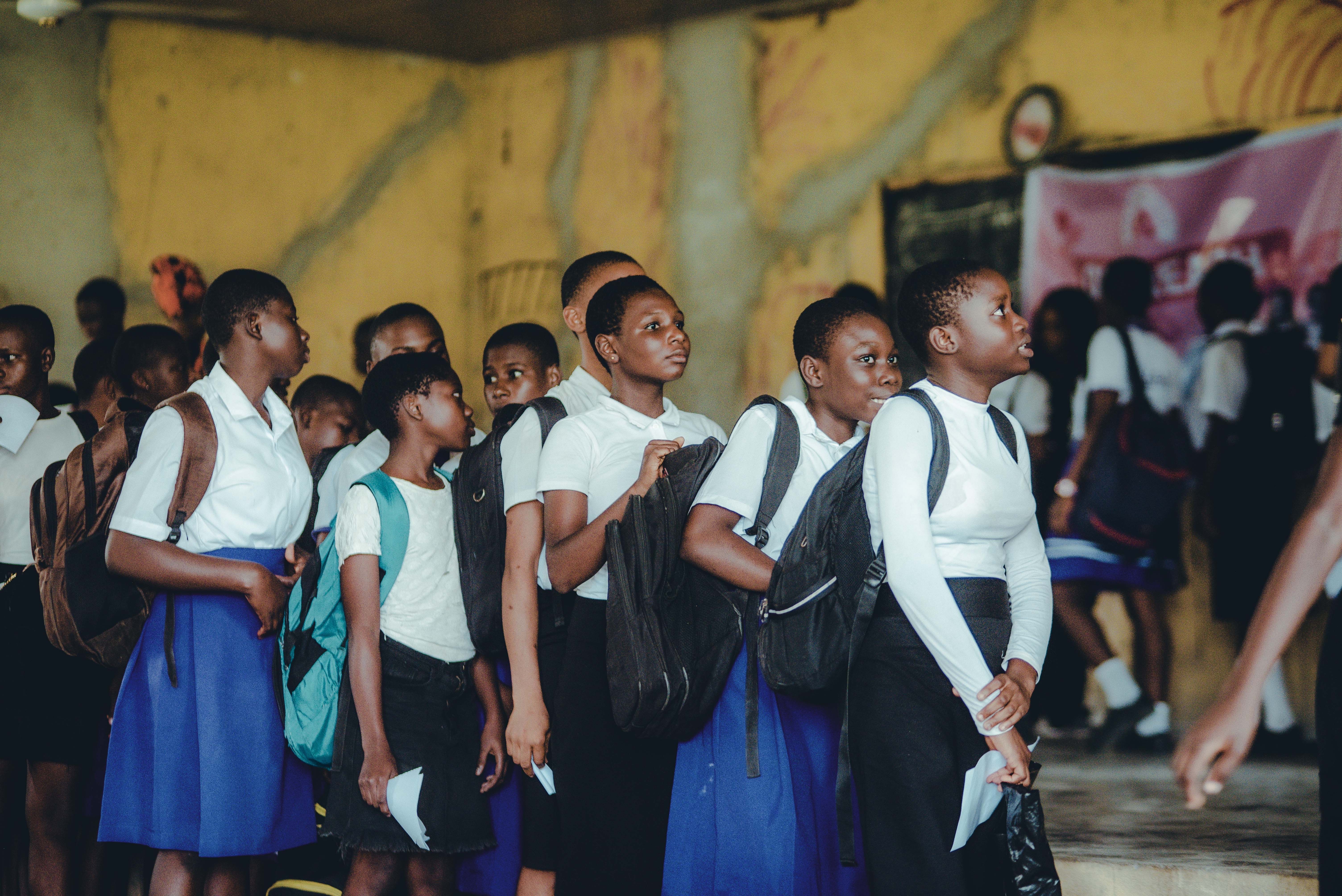 Group of Schoolchildren Lined Up Indoors · Free Stock Photo