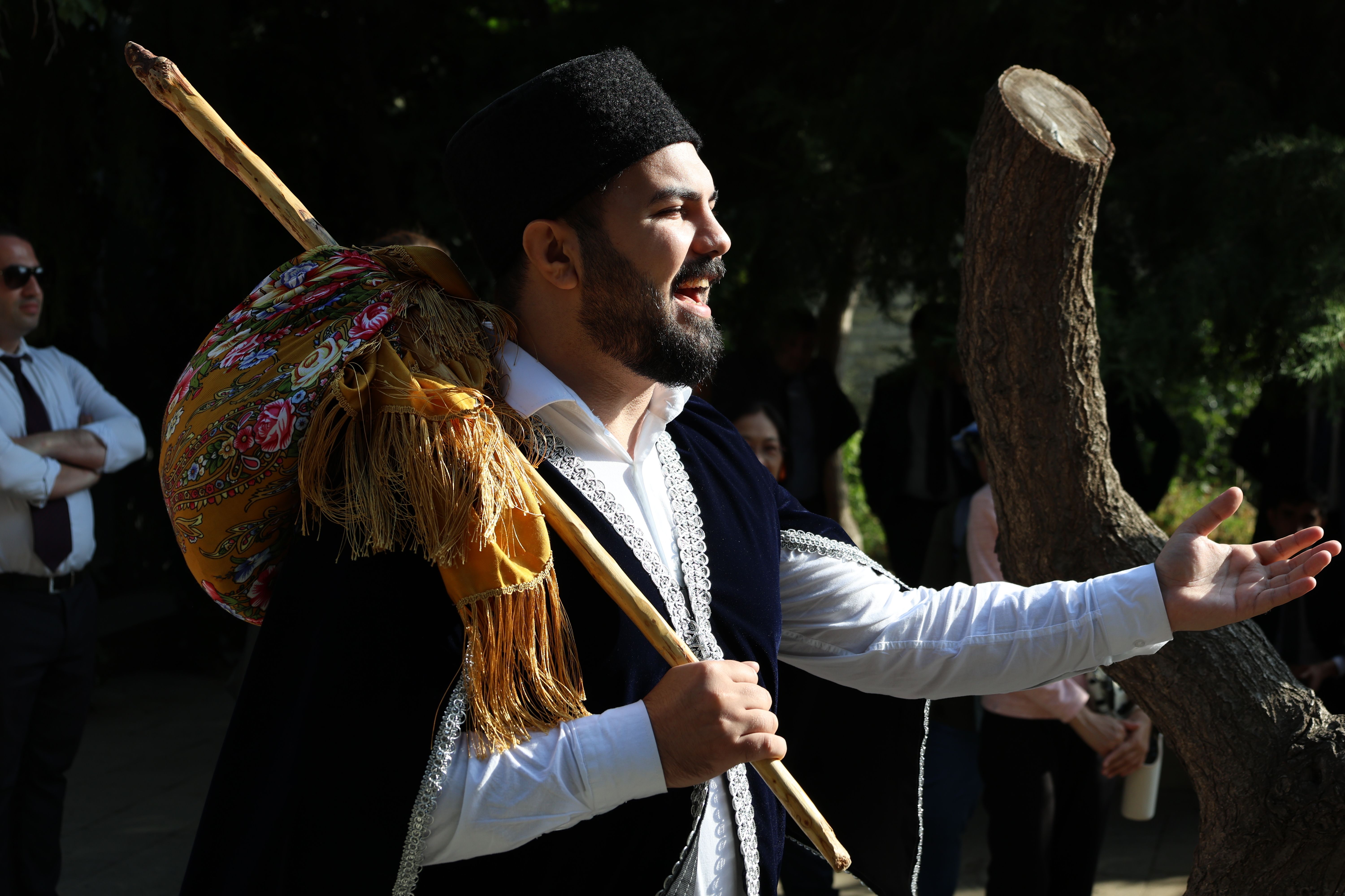 Free Smiling man in traditional folk attire performs outdoors under the sunlight. Stock Photo